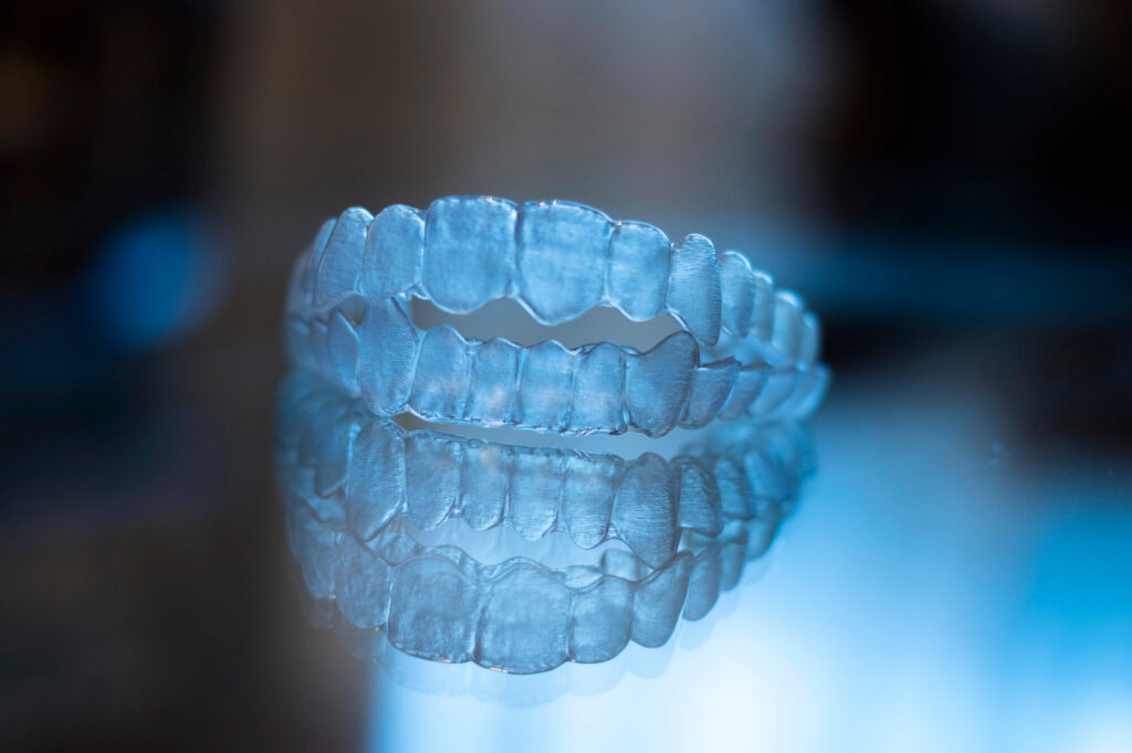 Two sets of clear aligners stacked on top of each other