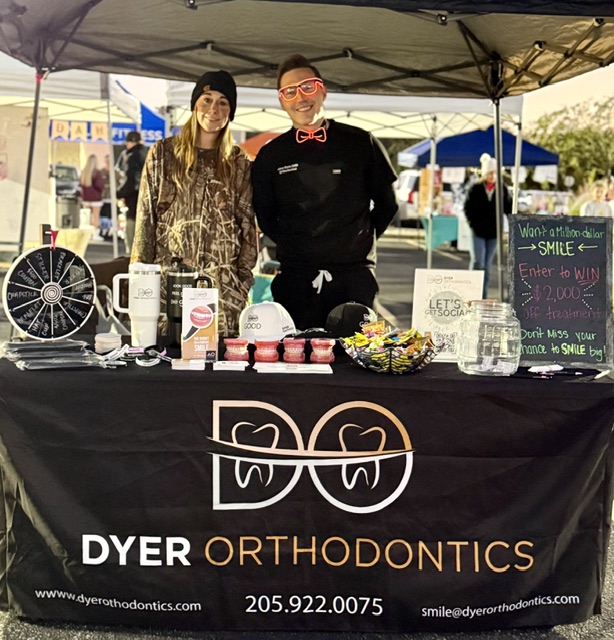 Dr Dyer At An Event Behind A Table