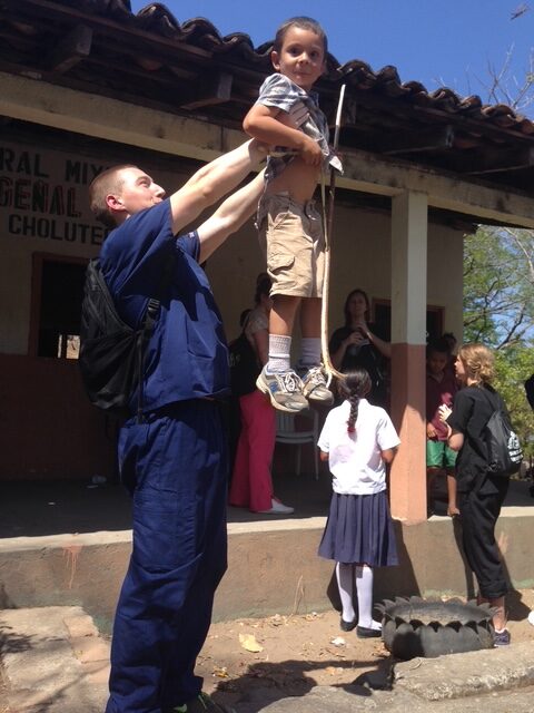 Dr Dyer Holding Up A Happy Little Boy