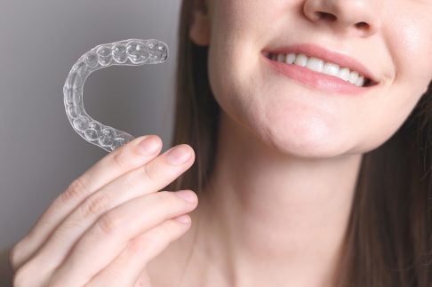 680b1ad3cb8095748be490ae_woman smiling with her new clear aligners birmingham
